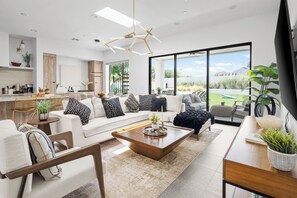 Bright, modern living room with stylish décor and seamless backyard access.