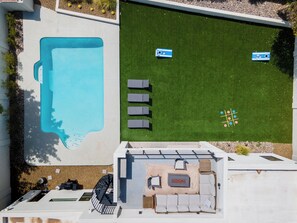 Backyard fun with a pool, lawn games, loungers, and a rooftop firepit lounge