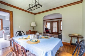 Spacious dining room opening to kitchen on one side, living room on other side