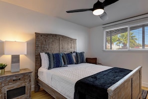 Cozy bedroom with rustic wood furnishings, luxe bedding, and natural light.