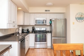 Kitchen is well equipped with both large and small appliances.