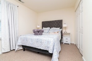2nd Fl Queen bedroom includes linens, black out curtains, a smart tv, and desk.