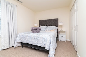 2nd Fl Queen bedroom includes linens, black out curtains, a smart tv, and desk.