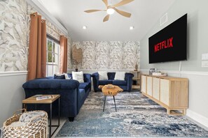 Cozy up and unwind! This living room is perfect for movie nights and relaxing, complete with a smart TV for all your streaming needs!