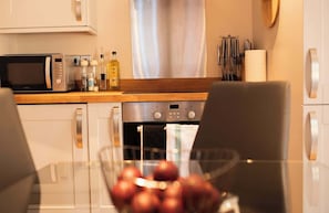 Efficient kitchen with a dining table at its heart, perfect for cooking, gathering, and enjoying meals together.