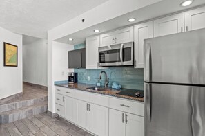 This kitchen is perfect for whipping up a family meal during a beach vacation.  The Ocean Decor adds to the flavor of this gorgeous kitchen which has a refrigerator, Smart TV stovetop burners, sink, microwave and plenty of cabinet space.