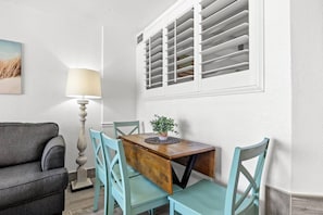 Enjoy oceanfront dining at a table for four with expandable seating, perfect for meals with a view. The charming nautical theme enhances the coastal vibe, making every bite feel like a seaside escape in the heart of North Myrtle Beach.