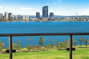 Indulge in unparalleled panoramic views from this stunning apartment, where the vibrant cityscape meets the tranquil beauty of the river. This image captures the essence of your stay: a private balcony offering a front-row seat to a captivating urban panorama.