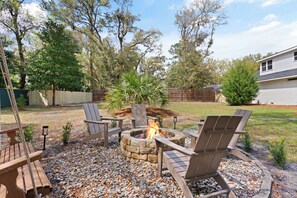 Fully fenced in backyard with cozy firepit-fit for relaxing after fun-filled day