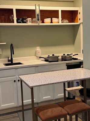 - Kitchen w/ electric stove
- Dining/work space for two