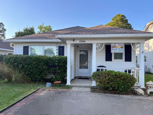 Front of house with parking space for four cars