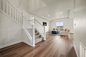 The open-concept living area features recessed lighting and sleek decor that blends comfort with contemporary design.