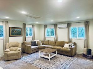 A spacious living room with a large sectional and a recliner