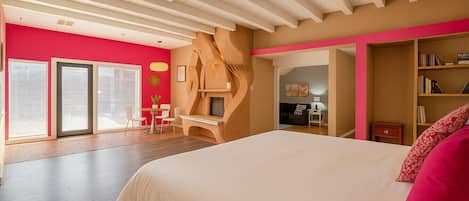 Kiva fireplace + master bed and the hallway to the living room where the sofa bed and TV is