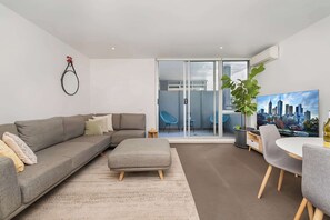 Glass sliding doors open out onto enclosed private balcony
