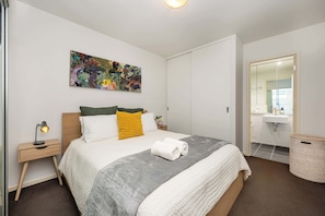 Plush queen size bed in bedroom