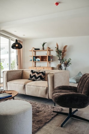 Earthy tones, cozy textures, and modern flair—this living space invites you to slow down, sip something warm, and vibe with your favorite playlist. Homey meets chic, effortlessly.