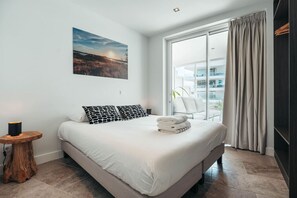 Crisp sheets, coastal light, and a vibe that says “rest easy.” This bedroom is your serene escape after a long day—simple, clean, and oh-so-inviting.