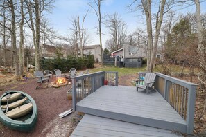 Spacious backyard with a firepit, plenty of seating, and direct lake access — perfect for summer nights, s'mores, and kayaking adventures.