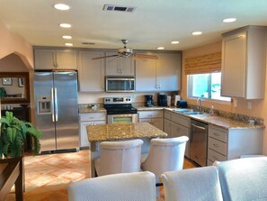 Chef’s kitchen stocked with premium appliances, cookware, and everything you need to cook with ease.