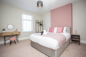 This master bedroom features a luxurious king-size bed with plush pillows and high-quality linens. Spacious and tastefully decorated, it’s designed for true relaxation.