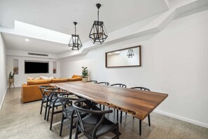 Savour generous ground-floor living with a striking timber dining table and elegant seating—ideal for shared meals and special moments.