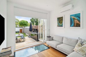 Unwind on the sleek grey sofa, set for ultimate relaxation in front of the TV.