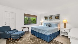Spacious primary suite featuring a plush king bed, extra large closets, cozy reading chair, and calming coastal decor for the perfect retreat.