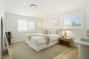 The primary suite is set with a king bed and attached ensuite. Central cooling ensures your comfort year-round.