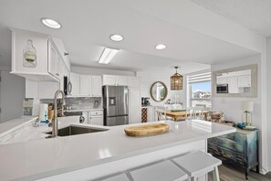 Modern, well-equipped kitchen with sleek appliances and a breakfast bar.