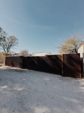back of property - secure gate around entire house. Space for 2 cars within gate