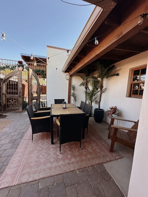 outdoor courtyard dining space - string lights are solar