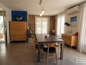 Air-conditioned dining room opening onto terrace