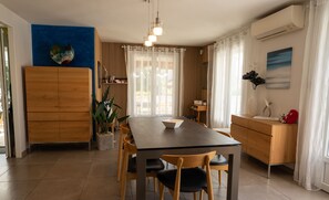 Air-conditioned dining room opening onto terrace