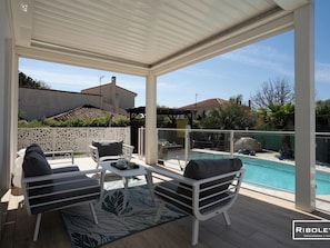 Large terrace with seating area and pergola