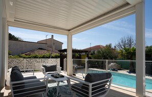 Large terrace with seating area and pergola