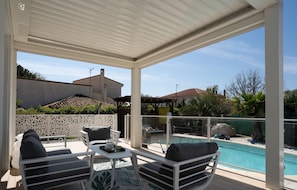 Large terrace with seating area and pergola