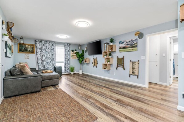 Bright, open-concept living room with comfy seating and a touch of local charm—ideal for winding down after your Alaskan excursions.