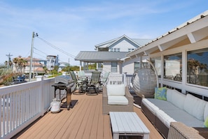 Spacious sundeck with BBQ grill, dining area & cozy seating for relaxing under the sun or stars.