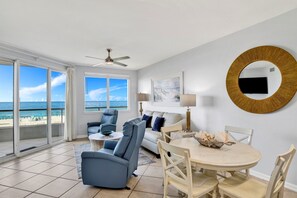 Living Room with BEAUTIFUL Gulf view, balcony access, wall mounted Smart TV, leather sleeper sofa and 2 leather recliners