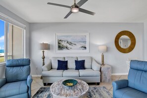 Living Room with BEAUTIFUL Gulf view, balcony access, wall mounted Smart TV, leather sleeper sofa and 2 leather recliners