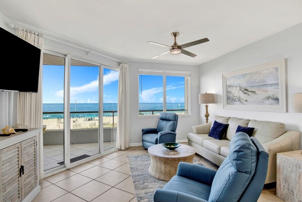 Living Room with BEAUTIFUL Gulf view, balcony access, wall mounted Smart TV, leather sleeper sofa and 2 leather recliners