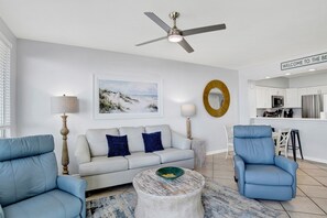Living Room with BEAUTIFUL Gulf view, balcony access, wall mounted Smart TV, leather sleeper sofa and 2 leather recliners