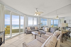 Living Room with BEAUTIFUL Gulf view, balcony access, wall mounted Smart TV and plenty of seating
