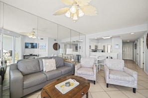 Living Room with BEAUTIFUL Gulf view, balcony access, wall mounted Smart TV and plenty of seating