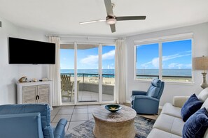 Living Room with BEAUTIFUL Gulf view, balcony access, wall mounted Smart TV, leather sleeper sofa and 2 leather recliners