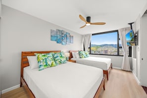 Bedroom with 2 queen-sized beds, TV, and great mountain views from the window