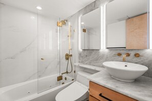 Fully remodeled bathroom with gorgeous stonework and heated floors.