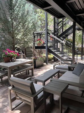In the summertime, your garden-level hideaway is abloom. The terrace transforms into a lush secret garden to relax in.