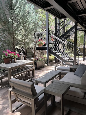 In the summertime, your garden-level hideaway is abloom. The terrace transforms into a lush secret garden to relax in.